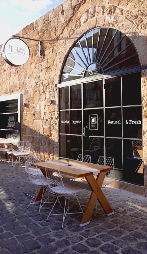 The Barn Batroun storefront with a stone arch