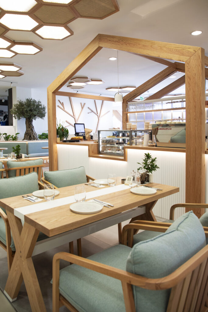 The Barn dining area with wooden frames and green seating